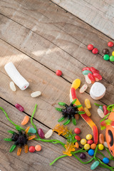 Halloween candies on wood table - holiday background