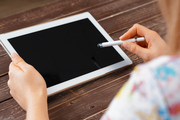 woman holding digital tablet, closeup
