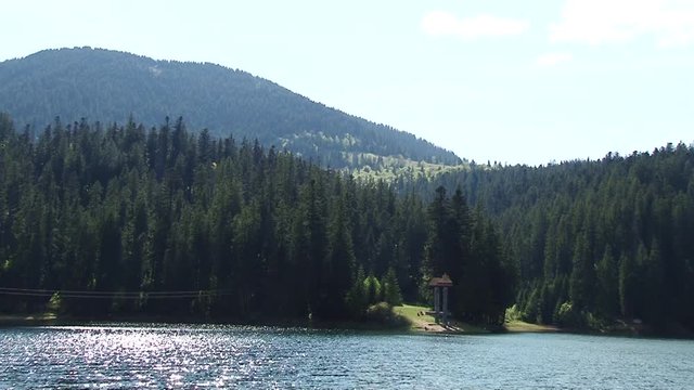 Beautiful landscape of big lake surrounded by forest and mountains