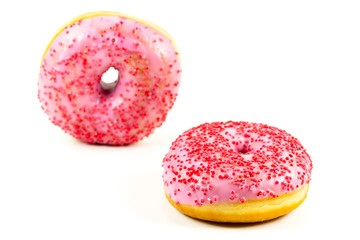 two fresh sweet pink donut with red sprinkles