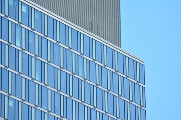 Abstract fragment of contemporary architecture, walls made of glass and concrete. Glass curtain wall of modern office building
