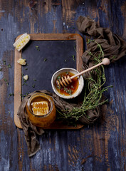Thyme honey with comb on chalk board