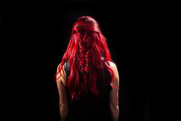 Very intense red color of hair on black background