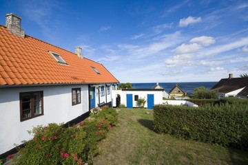 Fototapeta na wymiar Traditional tiny houses of fishing hamlet, Aarsdale, Bornholm, Denmark