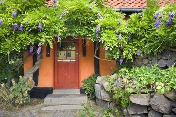 Fototapeta na wymiar Entrance door of traditional colorful half-timbered house in Allinge, Bornholm, Denmark