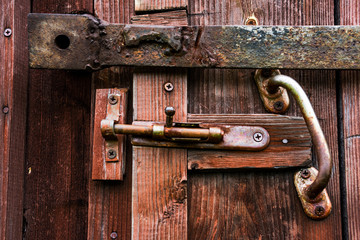 Closed latch on the old wooden door