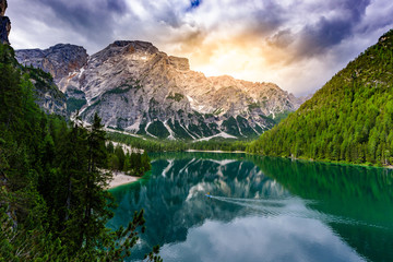 Stand up paddle board on Lake Braies (also known as Pragser Wildsee or Lago di Braies) in Dolomites Mountains, Sudtirol, Italy. Standup paddler in beautiful landscape scenery.