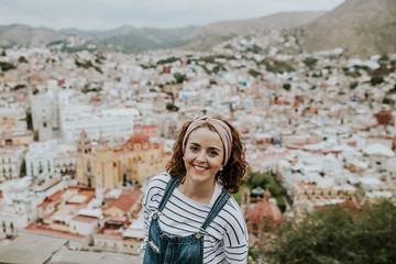 Fototapeta premium Beautiful view of the Mexican city of Guanajuato. Aerial view with a european tourist. Lifestyle portrait.