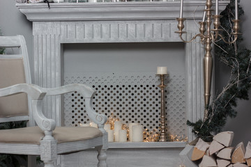 Christmas decoration - room with beautiful chair, fireplace and christmas tree