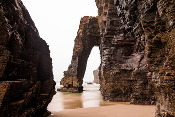 Natural rock arches on Cathedrals beach in low tide