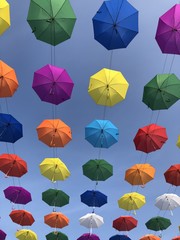 Fototapeta na wymiar Colourful umbrellas flying in the sky