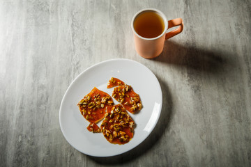Obraz na płótnie Canvas green tea and pumpkin seeds in caramelized sugar dessert