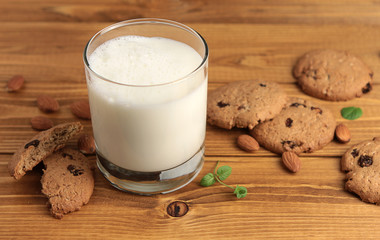 Glass of milk on a wooden background