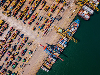 Industrial Cargo area with container ship in dock at port, Aerial view