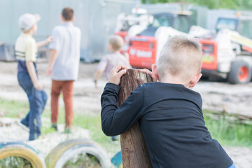 A little boy is playing alone on the playground. The problem of socialization of the child in the...