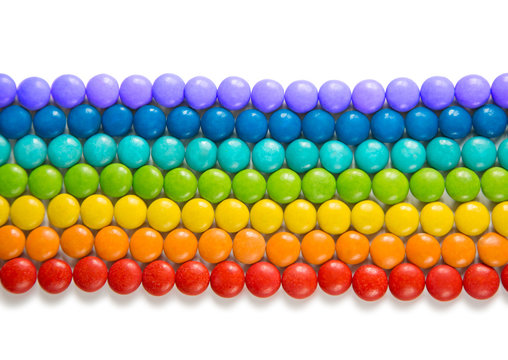 Creative Composition Of Round Candy Dragees In Rainbow Colors