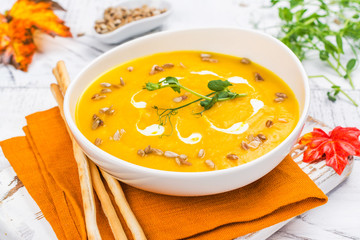 Pumpkin soup on autumn background