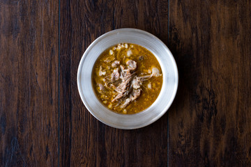 Turkish Soup Beyran with Lamb Meat, Rice, Chopped Garlic and Vinegar Sauce Served with Salad.