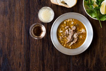 Turkish Soup Beyran with Lamb Meat, Rice, Chopped Garlic and Vinegar Sauce Served with Salad.