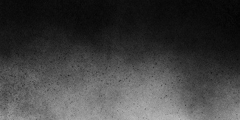 Subtle grain texture. Abstract black and white gritty grunge background. Dark paint spray particles...