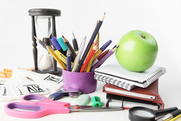 textbooks, Apple and school supplies on white background.photo with copy space