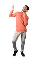 Full body of  Man in a pink sweatshirt pointing with the index finger a great idea and looking up on isolated white background