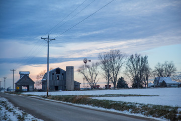 Fototapeta premium Cloudy Winter Dusky Sky over Old Derelict Farm and Windmill.