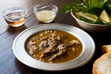 Turkish Soup Beyran with Lamb Meat, Rice, Chopped Garlic and Vinegar Sauce Served with Salad.