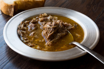 Turkish Soup Beyran with Lamb Meat, Rice, Chopped Garlic and Vinegar Sauce Served with Salad.