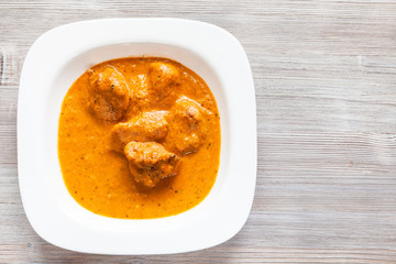 Murg Makhan Masala chicken pieces on wooden table