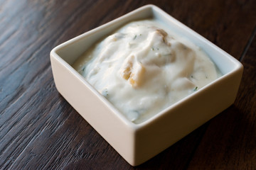 Turkish Appetizer Haydari with yogurt (Tzatziki) in square ceramic bowl.