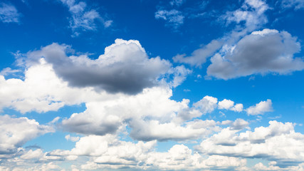 Naklejka na ściany i meble panoramic view of cumulus white and gray clouds