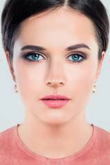 Fototapeta premium Elegant woman face closeup. Young beautiful woman fashion model with perfect makeup. Pink lips and nails