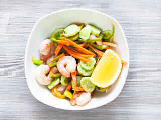 prawn salad from vegetables and shrimps on table