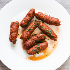 Mutton Seekh Kabab on white plate close up