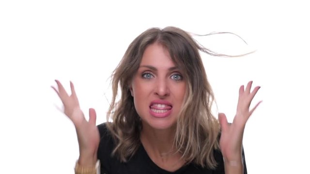 Frustrated angry young woman pulling hair isolated on white background