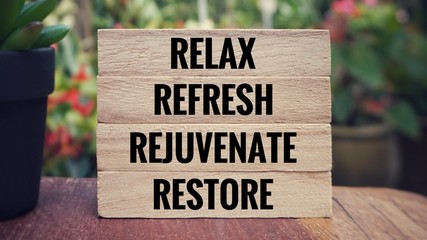 Motivational and inspirational quote - ‘Relax, refresh, rejuvenate, restore’ written on wooden...