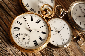 vintage pocket watches on aged wood