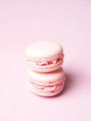 Pink colorful cake macaroon on pastel background, colorful almond cookies
