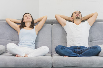 Happy couple relaxing on the couch at home in the living room