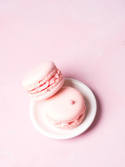 Pink colorful cake macaroon on pastel background, colorful almond cookies
