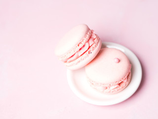 Fototapeta premium Pink colorful cake macaroon on pastel background, colorful almond cookies