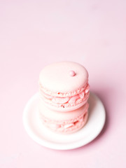 Pink colorful cake macaroon on pastel background, colorful almond cookies