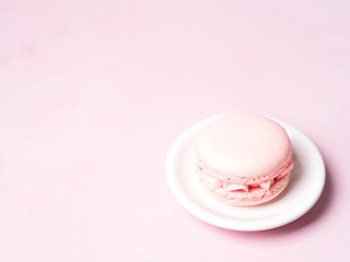 Pink colorful cake macaroon on pastel background, colorful almond cookies