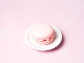 Pink colorful cake macaroon on pastel background, colorful almond cookies