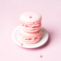 Pink colorful cake macaroon on pastel background, colorful almond cookies