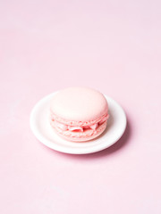 Pink colorful cake macaroon on pastel background, colorful almond cookies