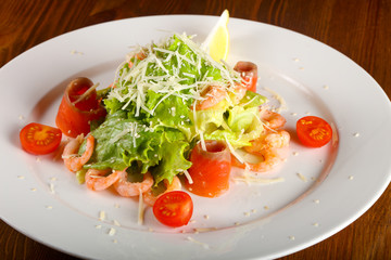 Caesar salad with shrimps and salmon
