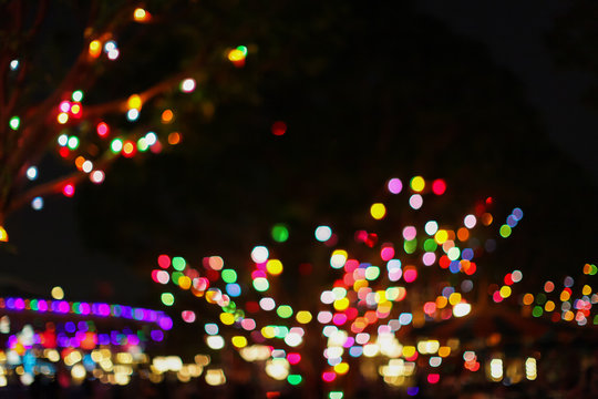 Defocus the Christmas city at night. colorful colored garland on the trees. abstract blurred backdrop