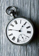 vintage pocket watch on aged wood, retro image